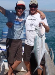 Father and son with a queenfish